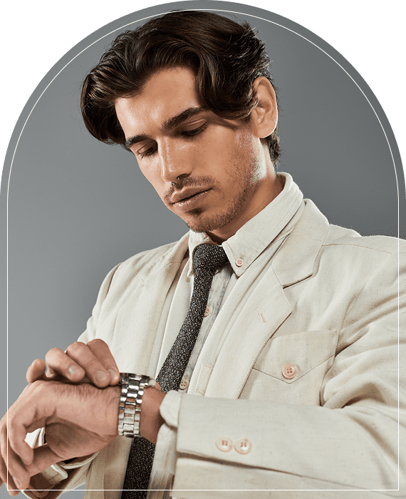 Man in suit checking his wristwatch.