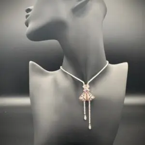 Elegant necklace with a butterfly pendant displayed on a mannequin bust.