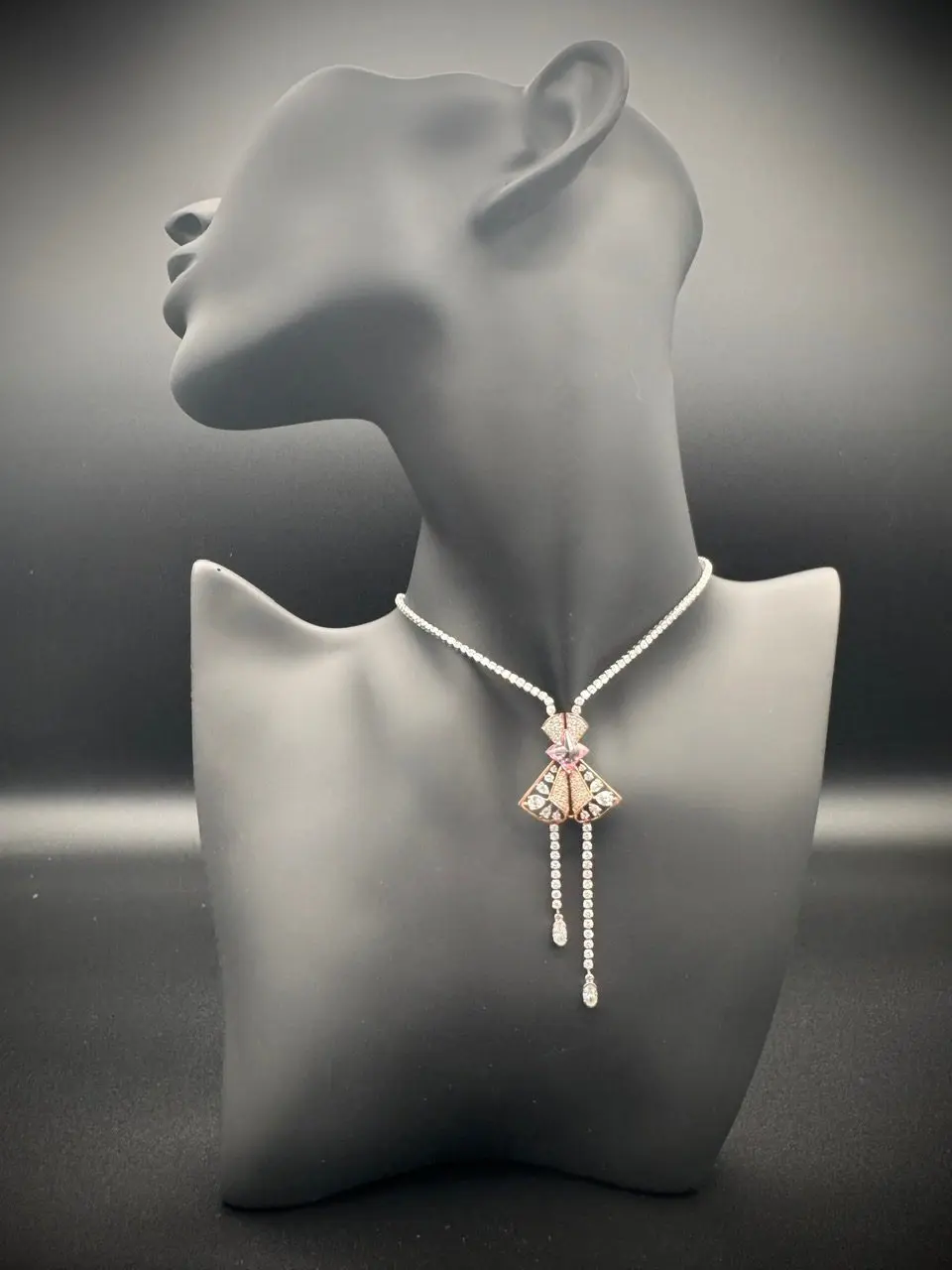 Elegant necklace with a butterfly pendant displayed on a mannequin bust.