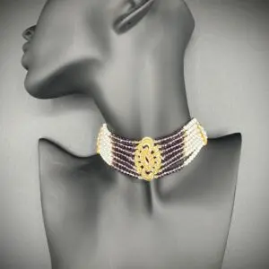 Elegant gold and white choker necklace on a mannequin.