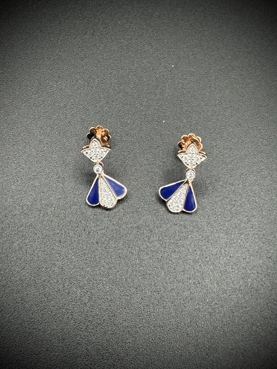 Elegant silver and blue angel-shaped earrings with rose gold accents.