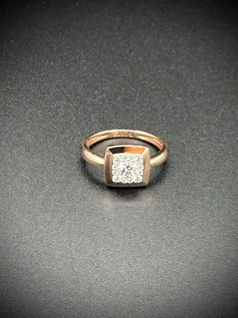 Elegant gold ring with a square diamond centerpiece.