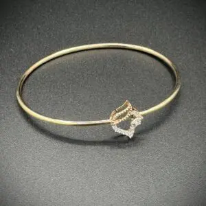 Elegant gold bracelet with a diamond-shaped centerpiece.