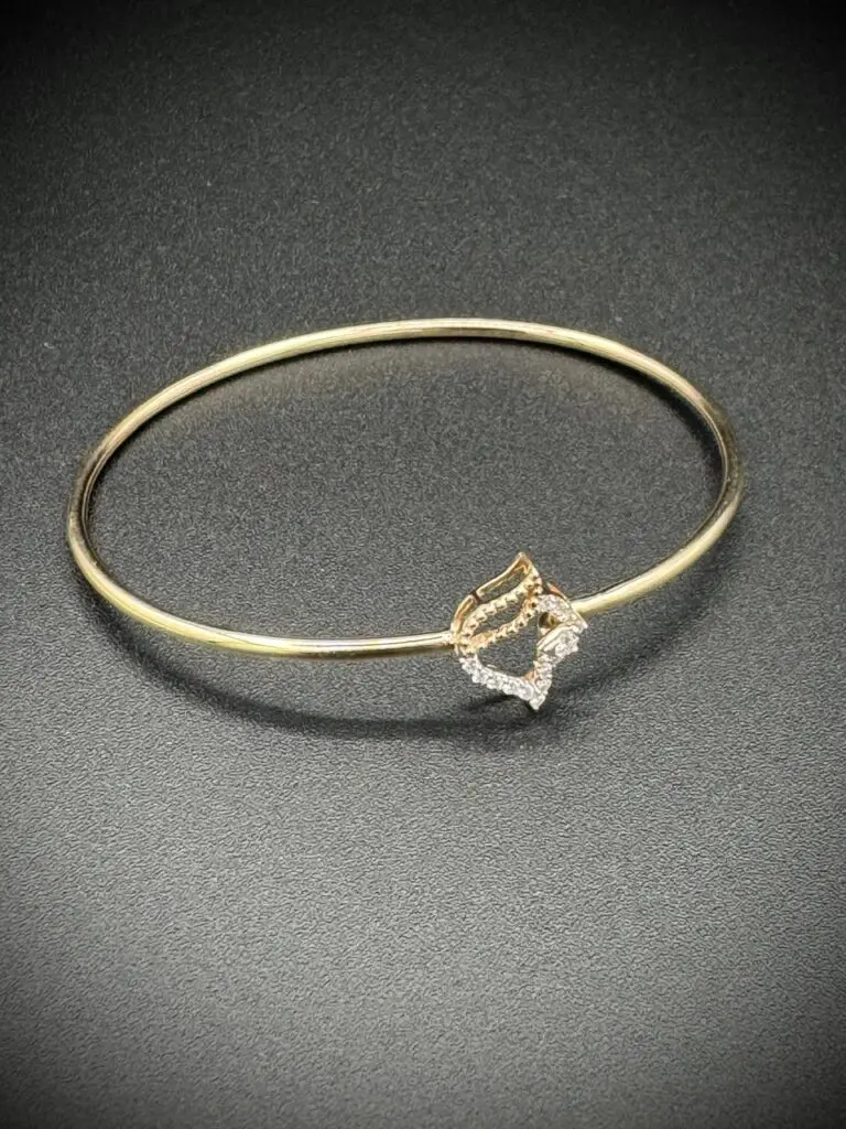 Elegant gold bracelet with a diamond-shaped centerpiece.