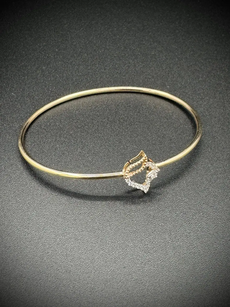 Elegant gold bracelet with a diamond-shaped centerpiece.