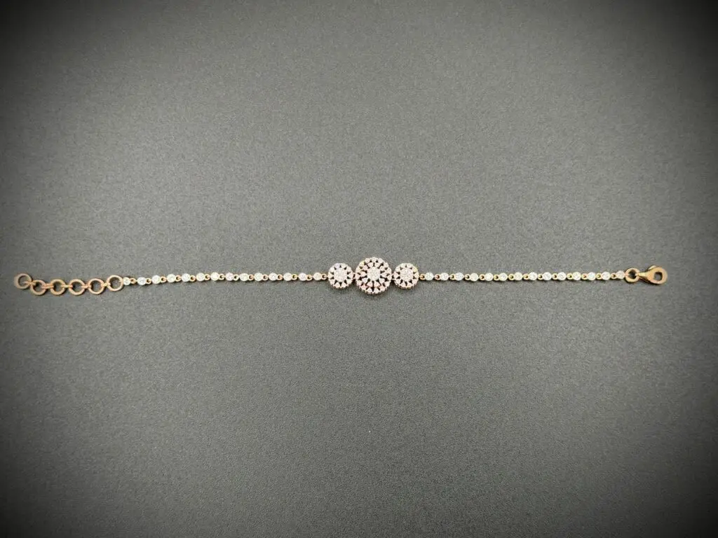 Elegant bracelet with three circular gems on a delicate chain.