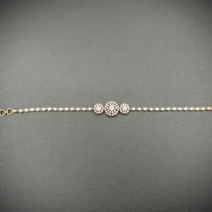 Elegant bracelet with three circular gems on a delicate chain.