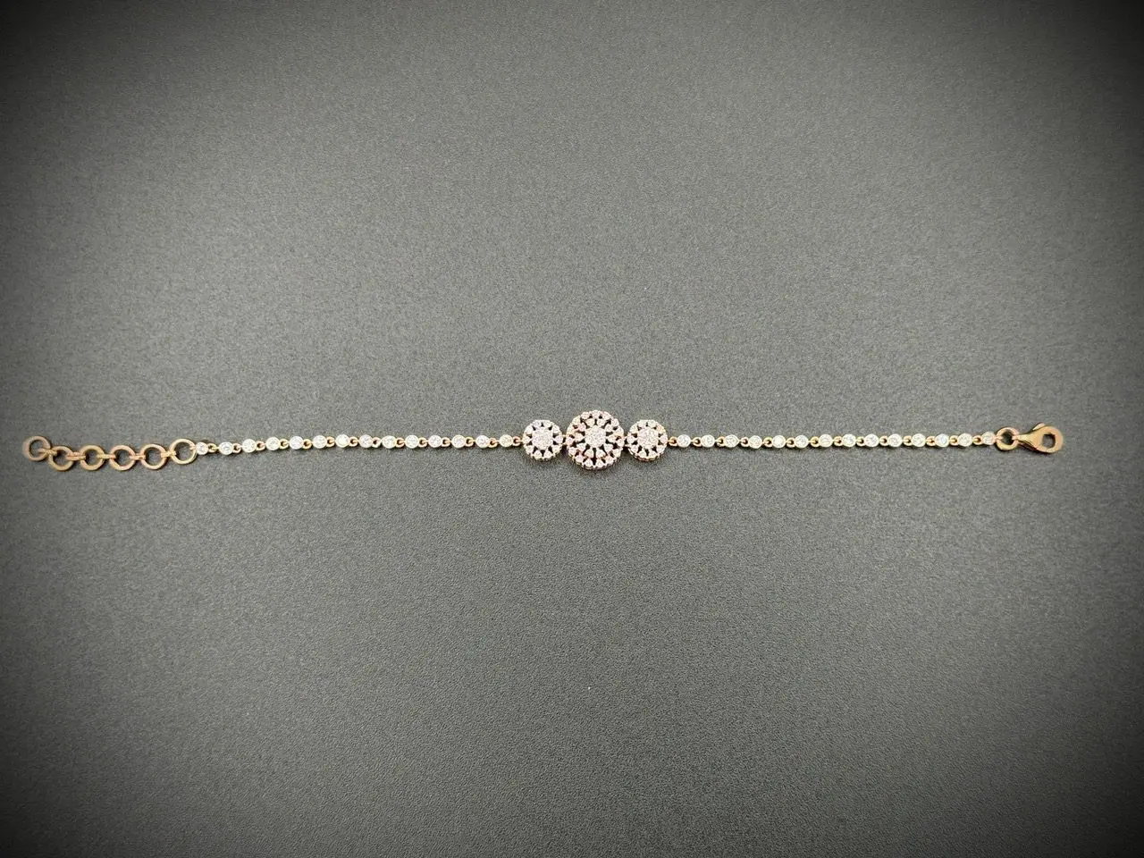 Elegant bracelet with three circular gems on a delicate chain.