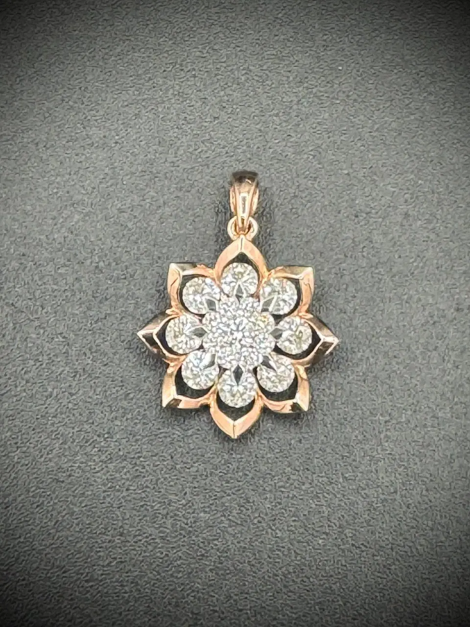 Elegant floral pendant with sparkling diamonds and rose gold details.