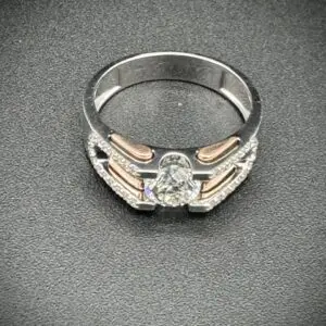 Elegant silver ring with intricate design and central gemstone.