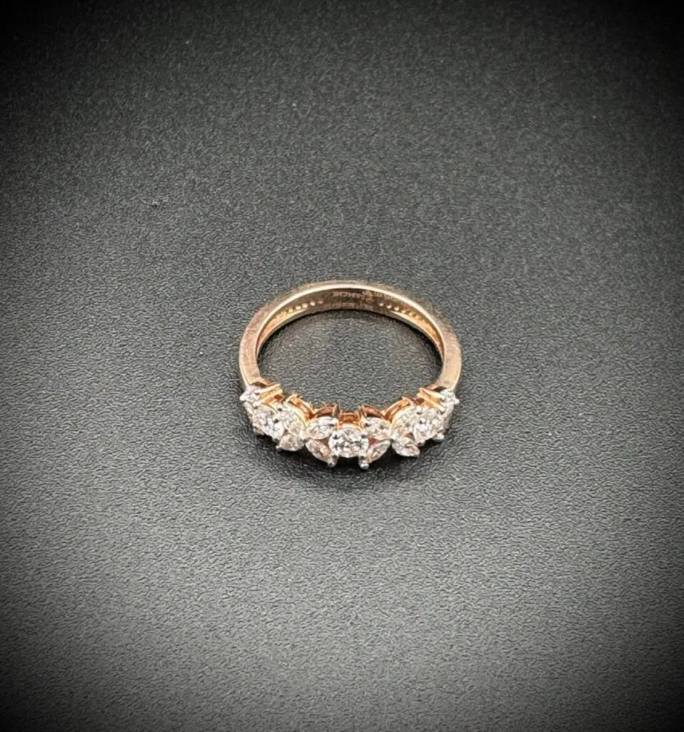 Elegant gold ring with a row of sparkling diamonds.