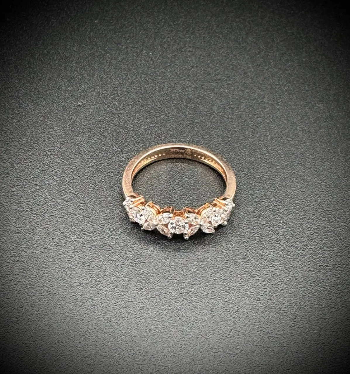 Elegant gold ring with a row of sparkling diamonds.
