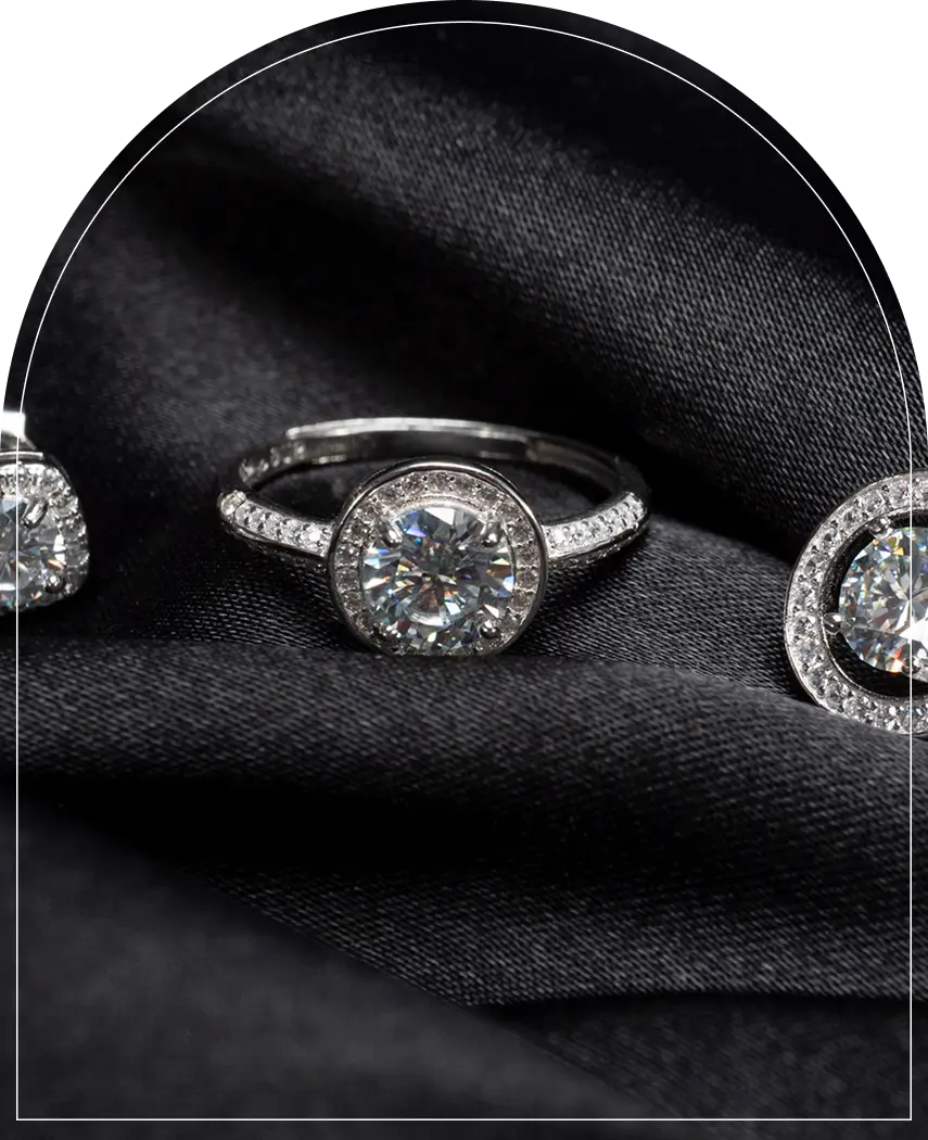 Diamond rings on black fabric background.