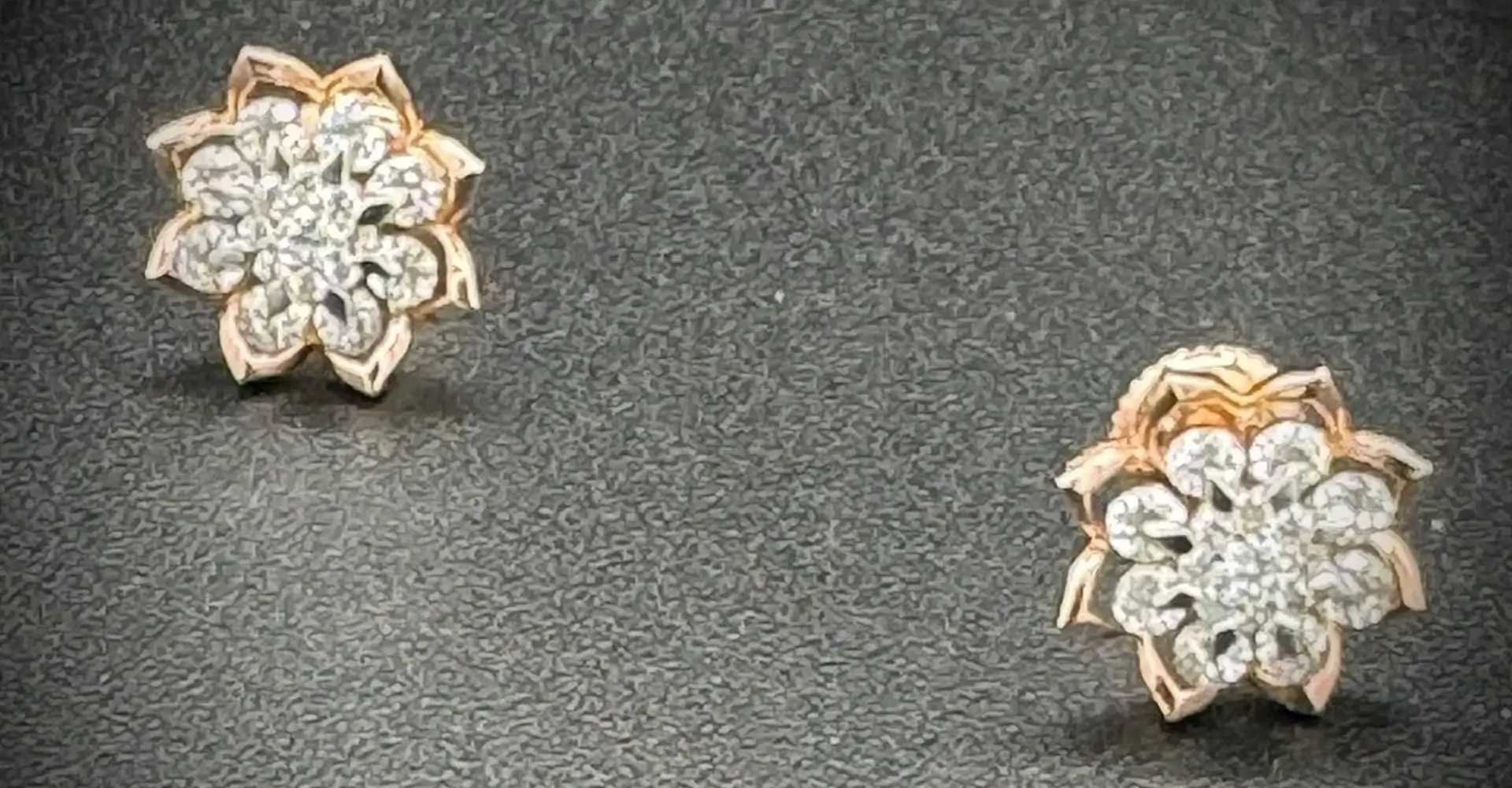 Pair of gold and diamond stud earrings with intricate designs.